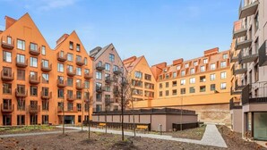 A residential complex with multiple apartment buildings, a central courtyard, and a pathway. - Granaria A607 | Best Location (Gdańsk)