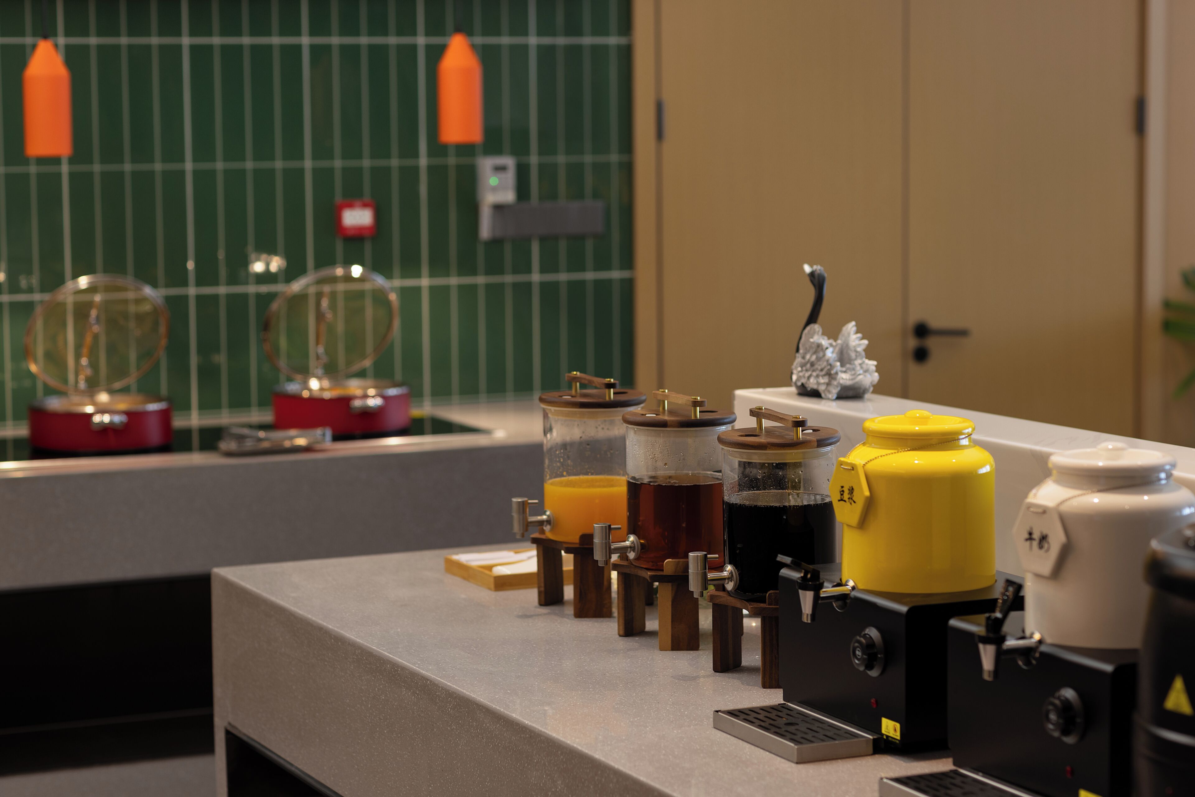 A kitchen counter with various appliances, including a coffee maker, a juicer, and a blender.