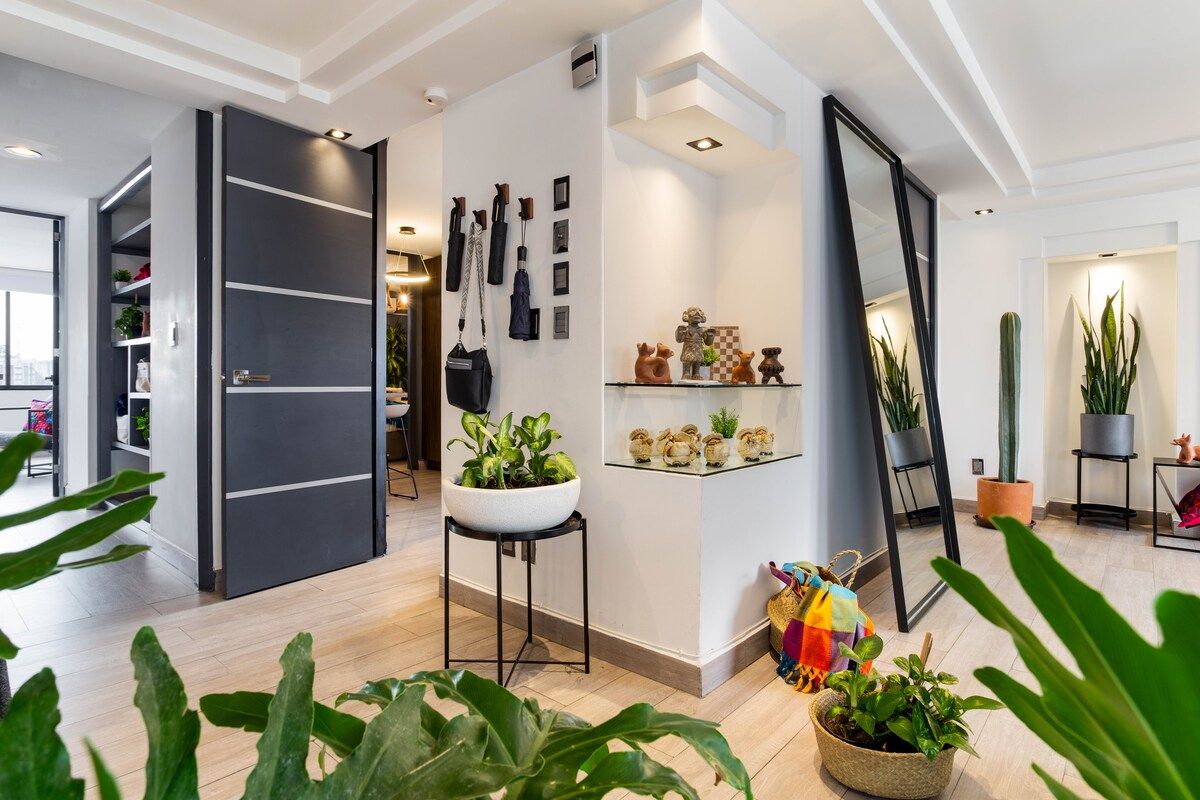 Mexican folk art, a full-length mirror and hooks for coats and umbrellas at the entry.