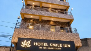 A multi-story hotel with a prominent sign reading 'HOTEL SMILE INN BY CN HOSPITALITY.' - Hotel Smile Inn-Next Railway Station (Bhubaneshwar)