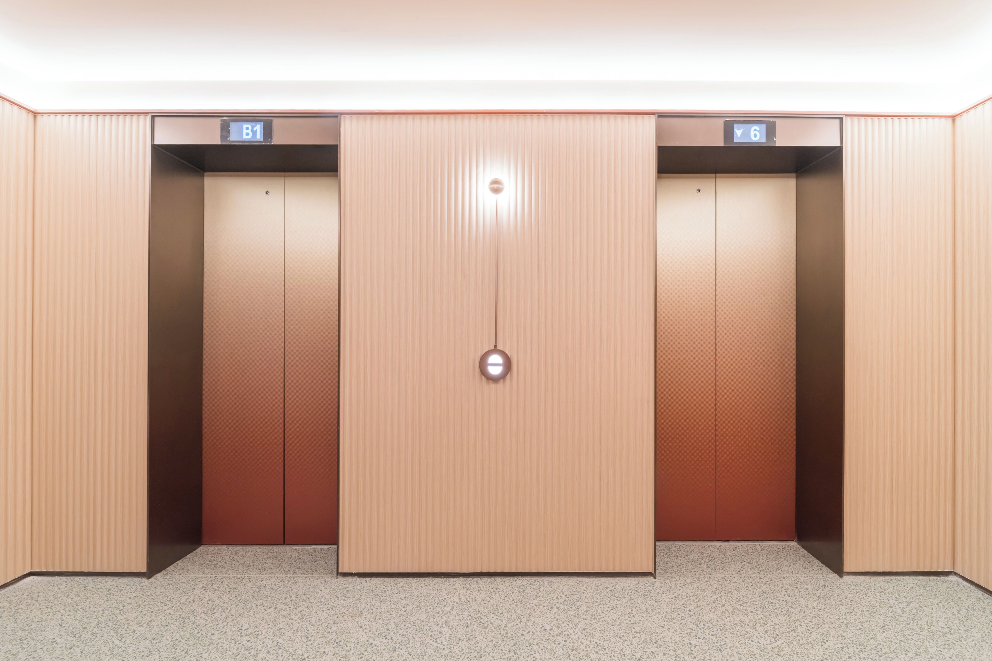 An elevator with two doors, each marked with a floor indicator.