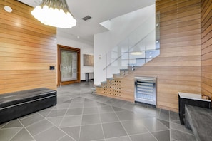 A modern interior with a wooden wall, a staircase, and a seating area. - Rooftop Oasis in Historic St. Augustine Panoramic Intracoastal Waterway Views (St. Augustine)