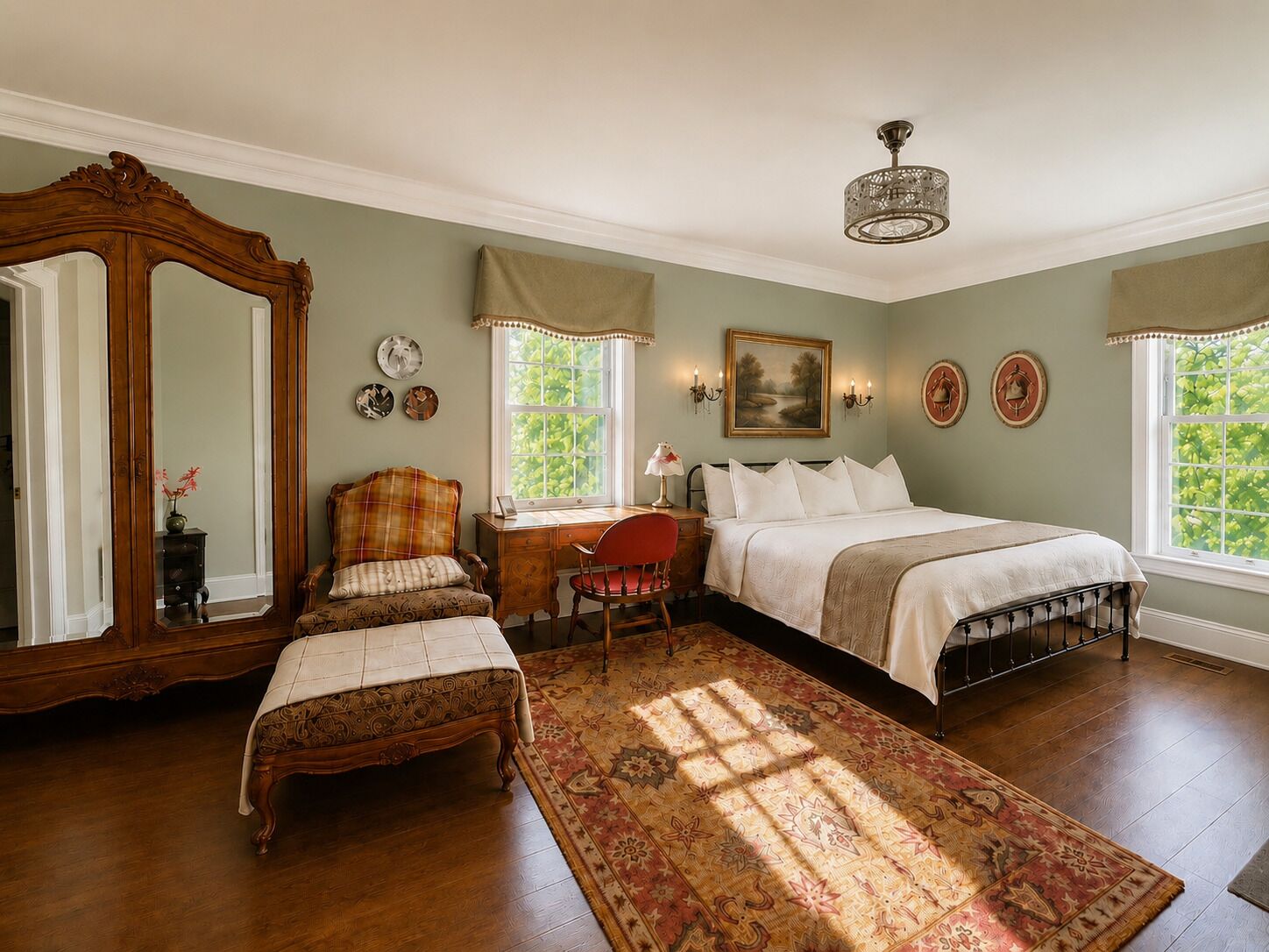 A bedroom with a large mirror, a bed, a desk, and a chair.