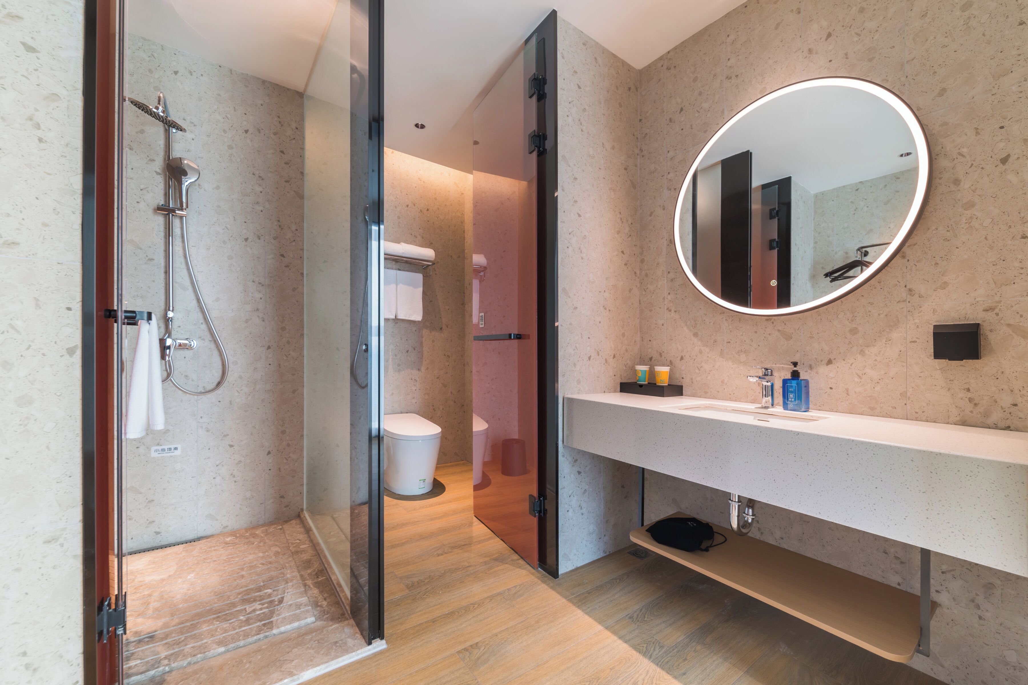 Un baño moderno con ducha, inodoro y tocador.
