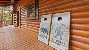 A wooden cabin with a porch, two wooden signs with bear silhouettes, and a window with a bear cutout. - Hid n Timber Getaway (Blue Ridge)