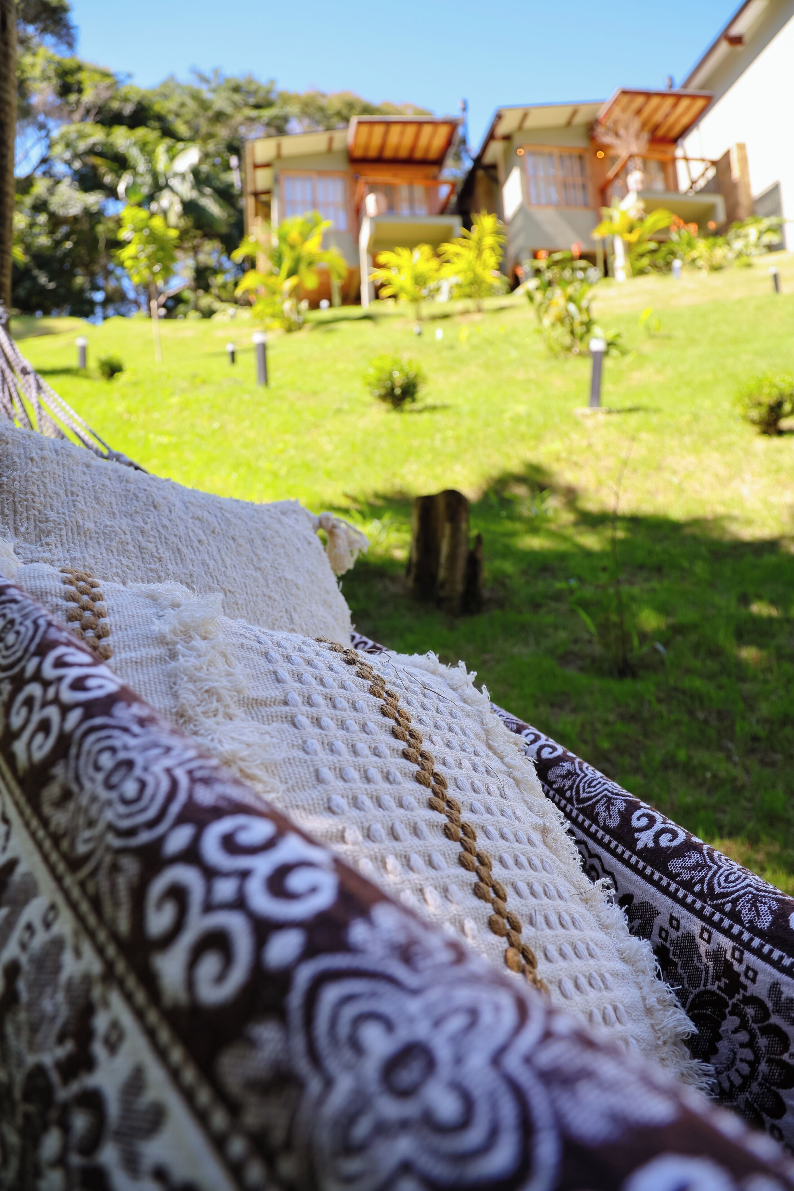 A view of a grassy area with a building in the background.