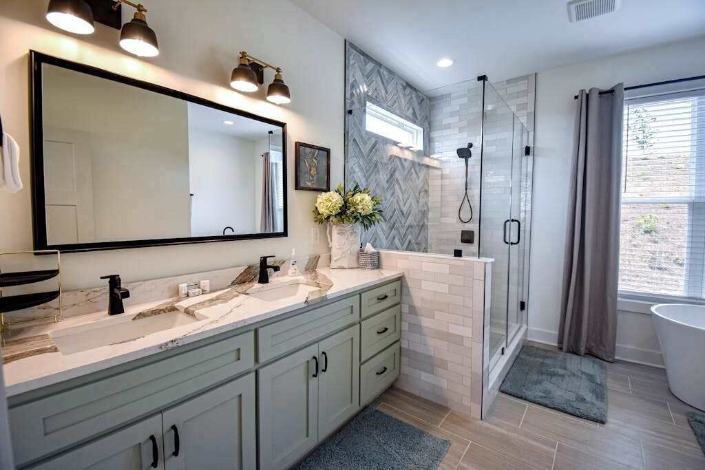 A modern bathroom with a large mirror, a shower, and a bathtub.