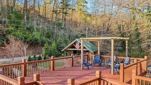 A wooden deck with chairs and a gazebo, surrounded by trees. - Timpson Cove Haven Stay (Clayton)