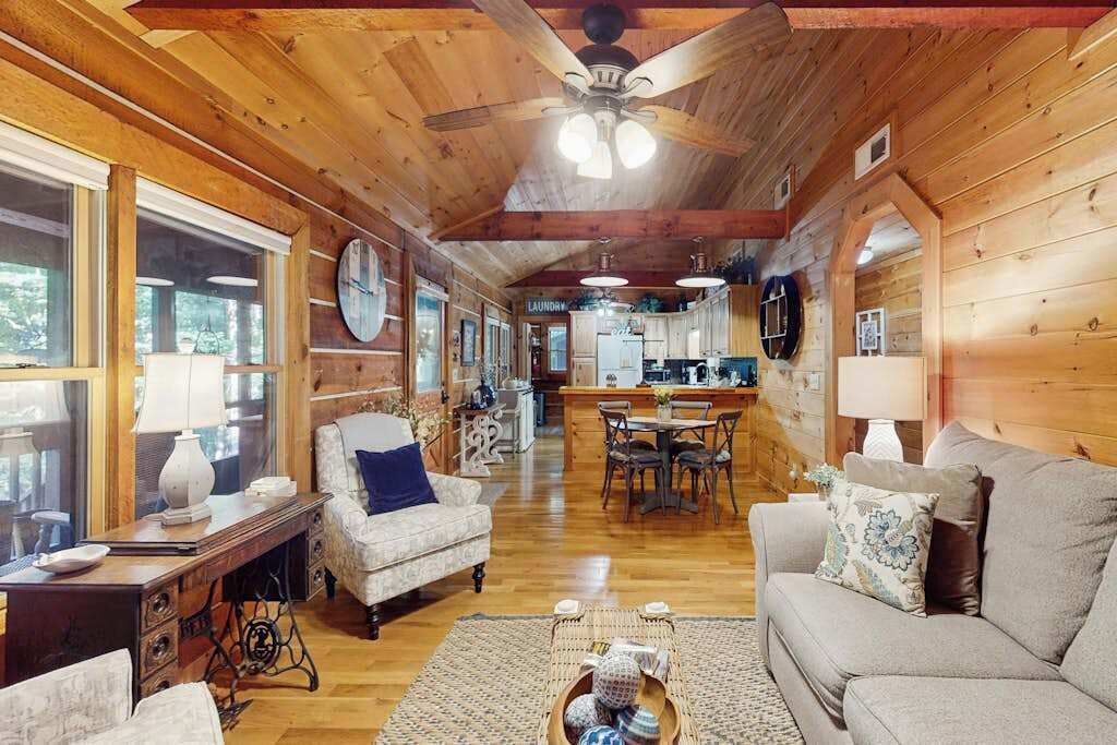 A wooden interior with a dining area, kitchen, and living room.