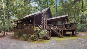 A cabin with a porch, a staircase, and a deck. - Swiss Puure Huus Cabin (Blue Ridge)