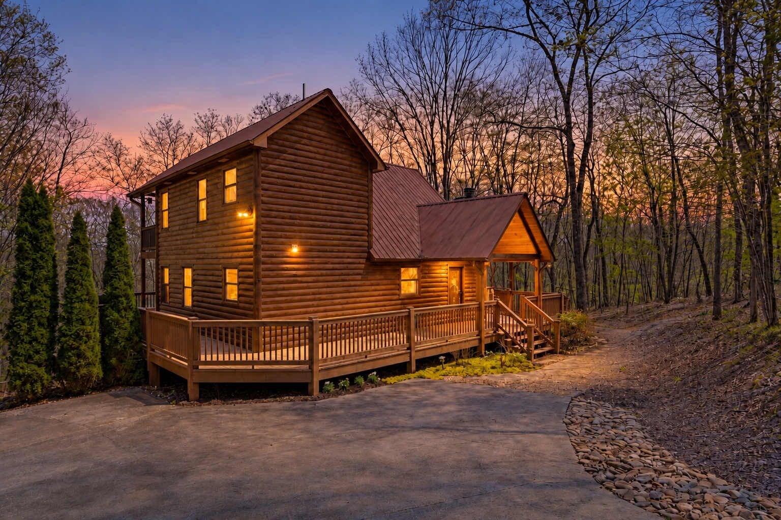A log cabin with a porch, a deck, and a driveway.