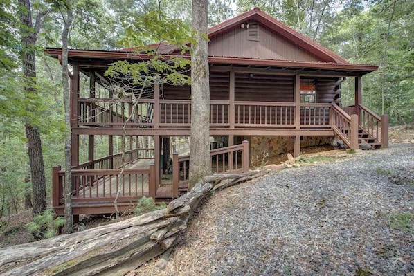 A cabin with a wooden deck, a staircase, and a log foundation. - River Ranch Ellijay Stay (Ellijay)