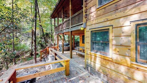 A wooden cabin with a balcony, a deck, and a fireplace. - Indian Rock Lake Cabin (Cherry Log)