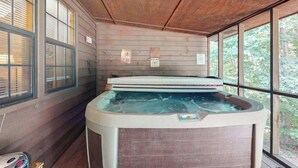 A hot tub in a room with wooden walls and large windows. - Lazy Acres Cabin Sautee (Sautee Nacoochee)