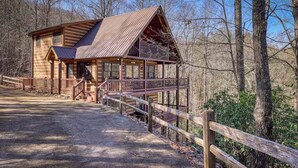 A rustic cabin with a porch, a staircase, and a wooden fence. - Dogwood Overlook Cabin (Mineral Bluff)