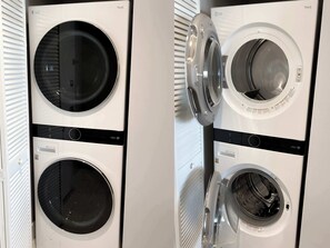A row of LG ThinQ washing machines with a front-loading design. - Sun & Water - 2BR - Bay View (Hallandale Beach)