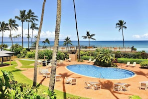 A pool area with lounge chairs, a pool, and a view of the ocean. - Oceanfront Maui Condo | 1BR at Hale Ono Loa | Pool & Sunset Views (Lahaina)