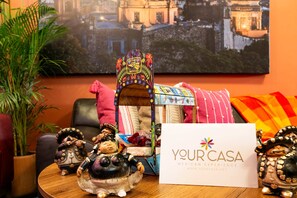 A table with a decorative item, a sign, and a framed picture. - Condesa 7-suite villa · hot tub & pool table (Mexico City)