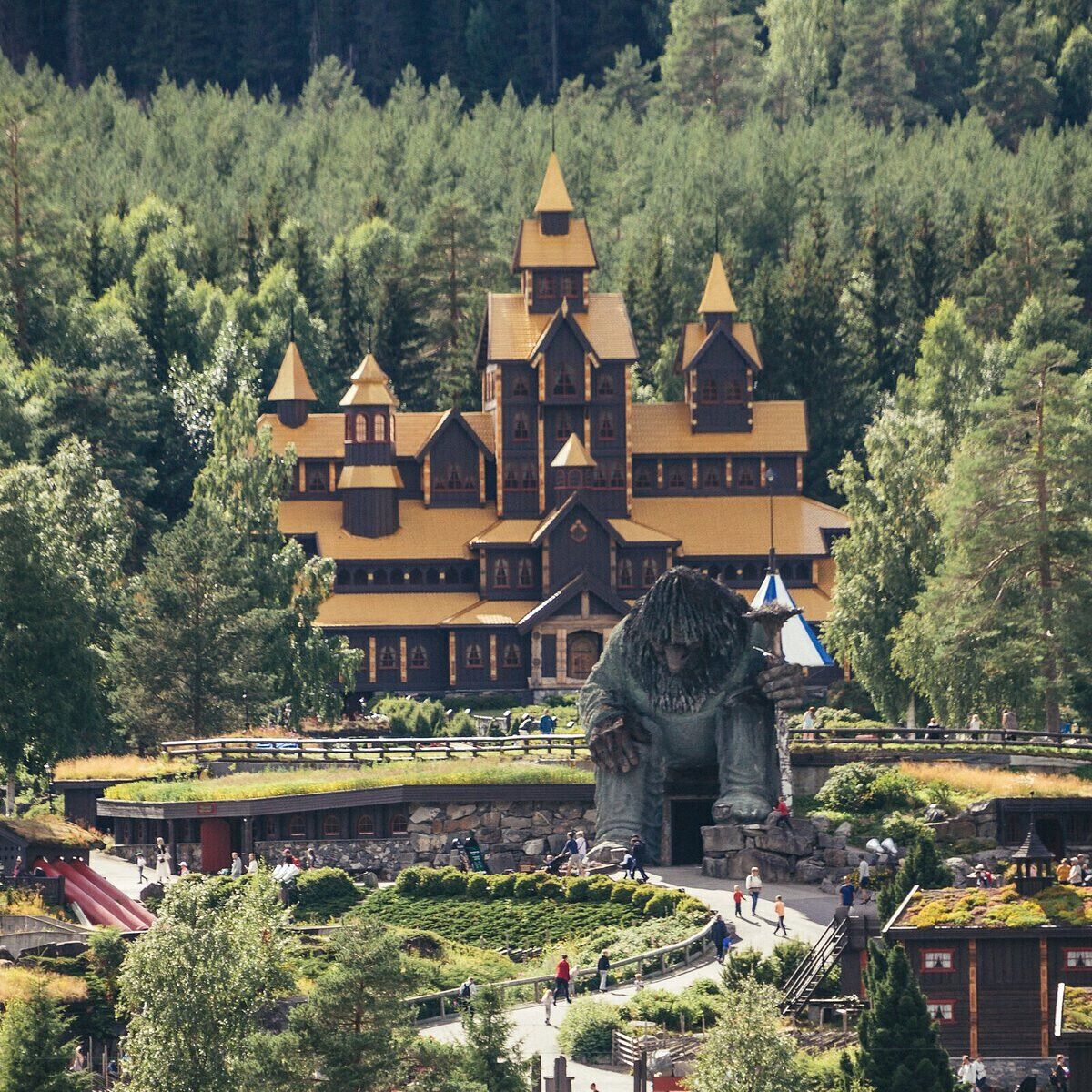 A large building with multiple towers and a central statue.