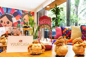A room with a sign reading 'YOUR CASA MEXICAN EXPERIENCE' and a decorative archway. - Colorful Condesa 3BR with Mural, Parking & AC (Mexico City)