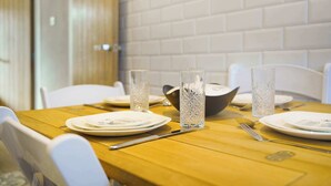 A dining table set with plates, cutlery, and decorative glassware. - Chic 3BR Rotherham Parking WIFI By stay with us (Wath upon Dearne)