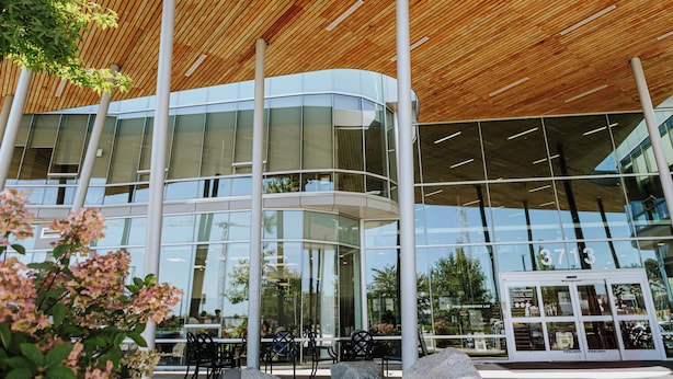 A modern building with a curved glass facade, large windows, and a wooden ceiling. - Hotel Burnaby (Burnaby)