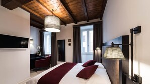 A hotel room with a bed, a TV, a desk, and a large window. - Dolcevita Panisperna 4 - Liz Apartment (Rome)