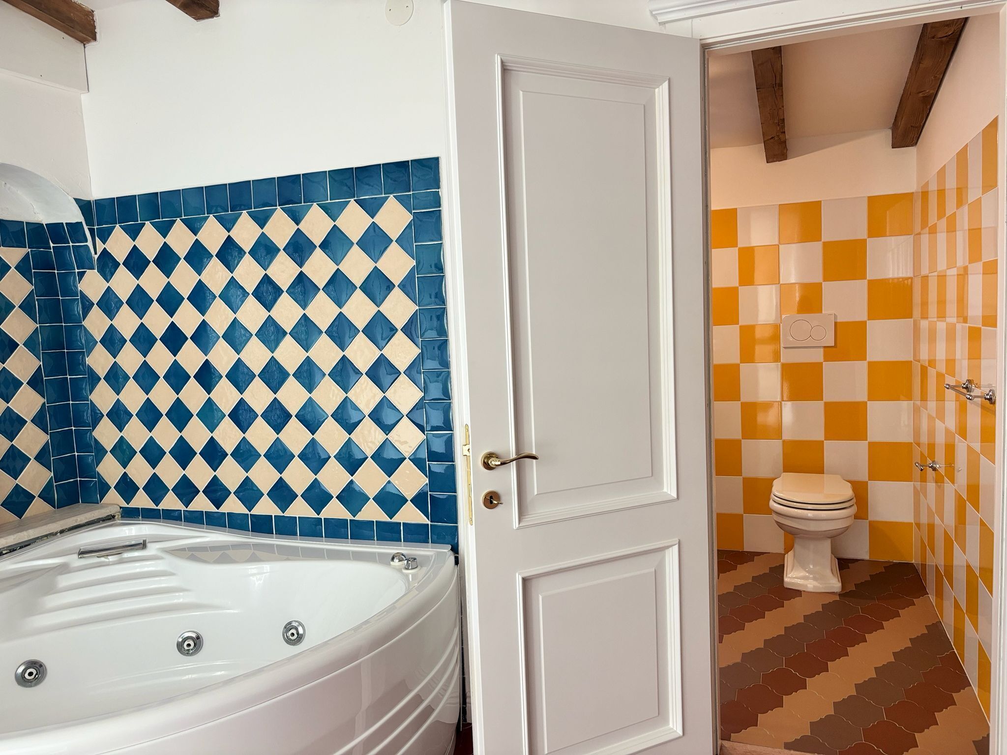 A bathroom with a white bathtub, a white door, and a toilet.