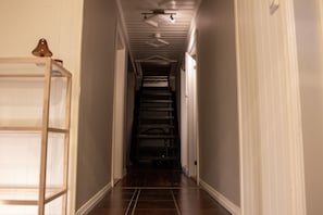 A narrow hallway with a wooden ladder, a staircase, and a ceiling fan. - Arctic Comfort 1, Tromsø (Tromsø)