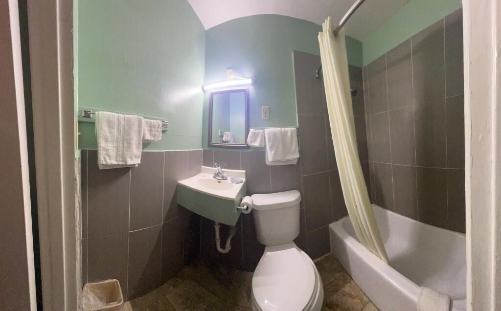 A bathroom with a toilet, sink, and bathtub.