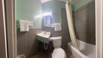 A bathroom with a toilet, sink, and bathtub.