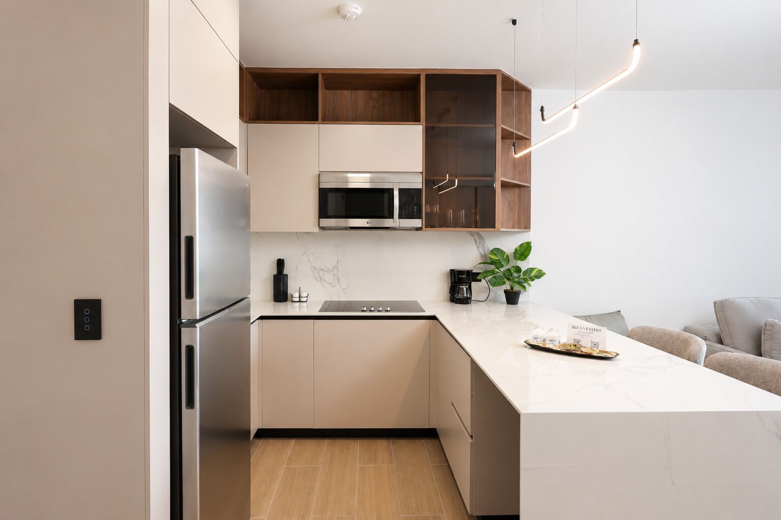 A modern kitchen with a built-in oven, microwave, and a coffee maker on the counter.