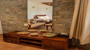 A bedroom with a wooden bed, a nightstand, a dresser, and a large mirror reflecting the room. - Premium King Bed Room Palette Hotel Amritsar (Amritsar)