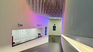 A hallway with a reception desk labeled "RMG" and "Staying Cool". - The Bullring Studio in Birmingham City Centre (Birmingham)