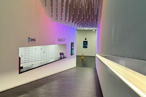 A hallway with a reception desk labeled "RMG" and "Staying Cool". - The Bullring Studio in Birmingham City Centre (Birmingham)