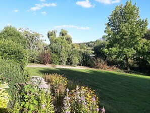 A well-maintained golf course with a variety of vegetation and trees.