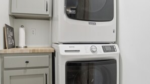 A compact laundry room with a washing machine, dryer, and a cabinet. - Doodle's Mountain Cape - Raystown Lake - Aunt Susie's (James Creek)