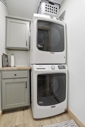 A compact laundry room with a washing machine, dryer, and a cabinet. - Doodle's Mountain Cape - Raystown Lake - Aunt Susie's (James Creek)