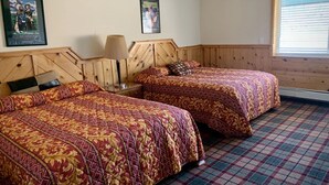 A room with two beds, wooden headboards, a plaid carpet, and two framed pictures on the wall. - Room With Scenic Lake And Mountain Side Views (Panguitch)
