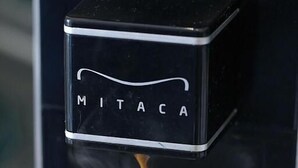 A coffee machine dispensing coffee into a cup with a logo. - Palazzo Ferrara  (Naples)