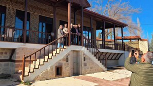 A building with a covered porch, stone steps, and a brick facade. - Philomelion Lodge (Aksehir)
