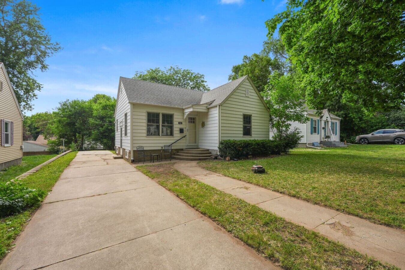 A single-story house with a front porch, a visible mailbox, and a driveway leading to the entrance.