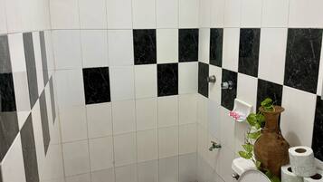 Een douche, handdoeken, zeep, shampoo