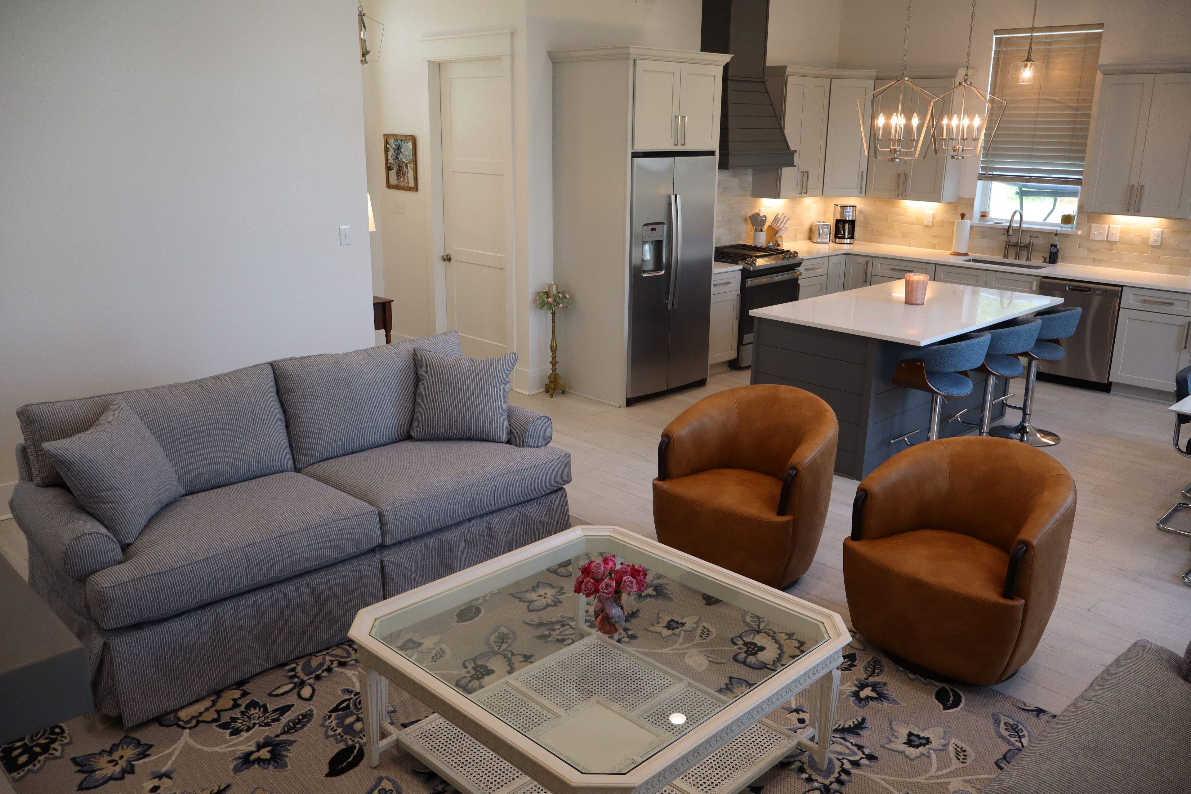 A modern living room with a sofa, armchairs, and a coffee table.
