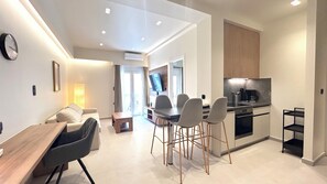 A modern apartment with a dining area, kitchen, and a living space. - Modern Bright 1BR next to Pasalimani & Marina Zeas (Pireas)