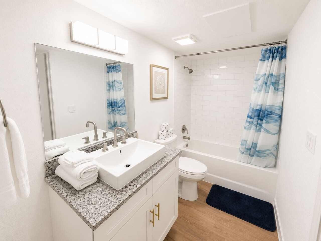 A bathroom with a sink, toilet, and shower.