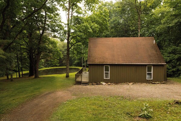 A small, single-story building with a sloped roof, a front porch, and a door.