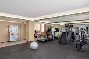 A gym with treadmills, an elliptical, and a stationary bike.