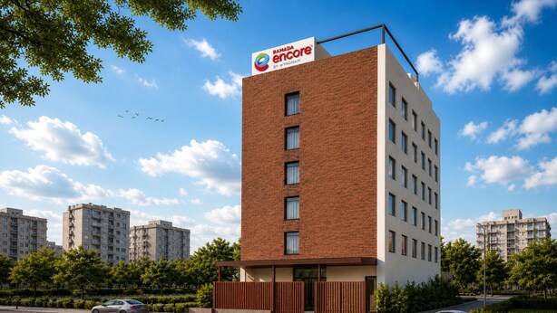 A modern building with a prominent sign for Ramada Encore by Wyndham. - Ramada Encore by Wyndham Vrindavan Rukmani Vihar (Vrindavan)