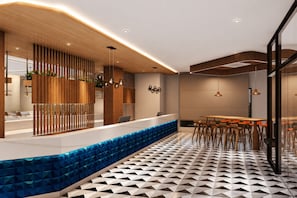 A modern interior with a reception desk, seating area, and patterned flooring. - Ramada Encore by Wyndham Vrindavan Rukmani Vihar (Vrindavan)